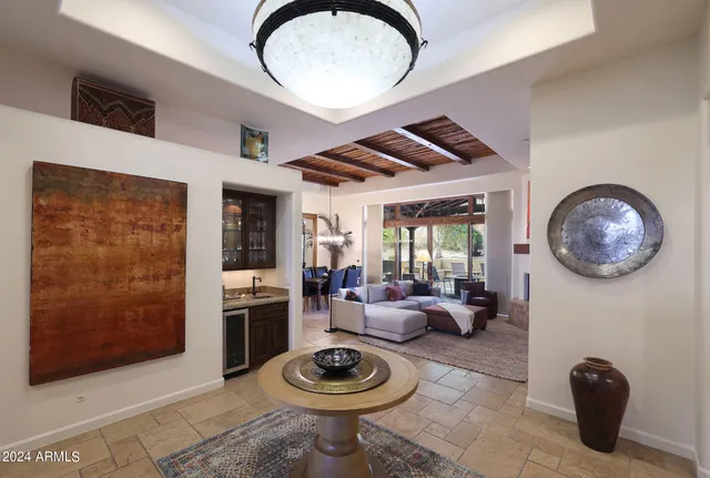 a living room with furniture a fireplace and a large window