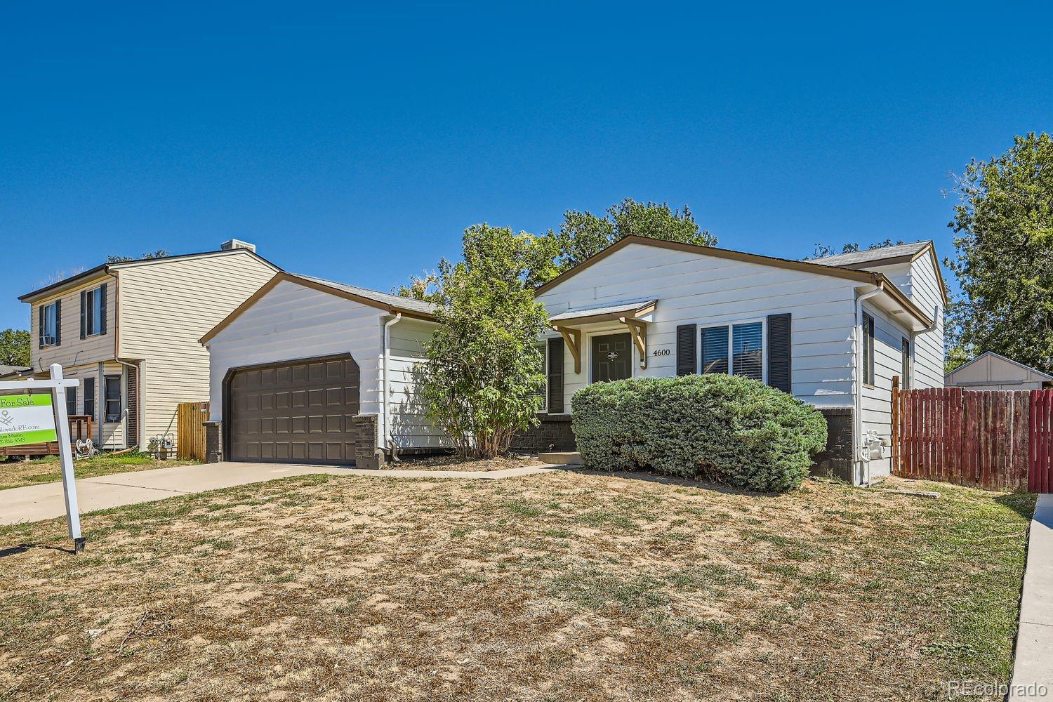 4600 Dillon Street Denver, CO 80239 - Photo 16 of 27 a front view of a house with a yard