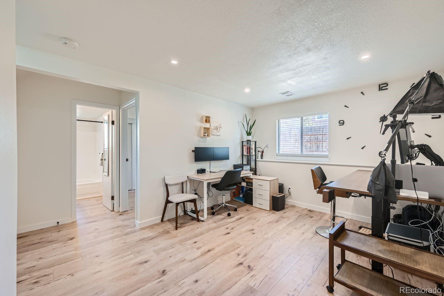 4600 Dillon Street Denver, CO 80239 - Photo 17 of 27 a living room with furniture a flat screen tv and a wooden floor