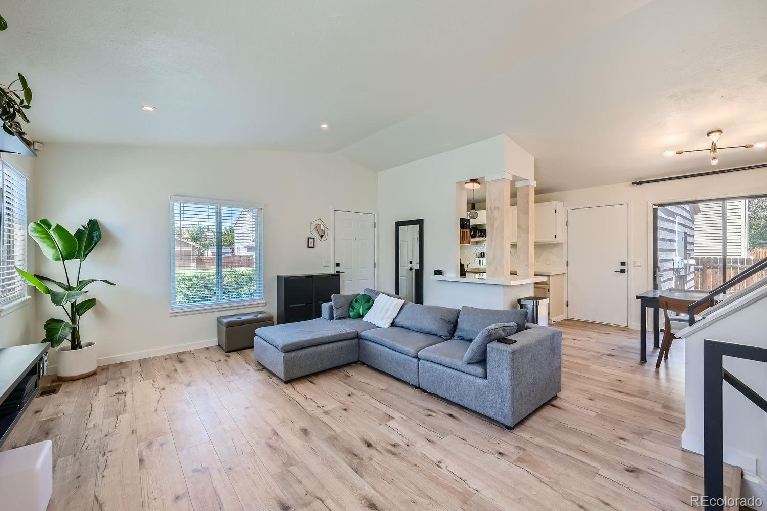 4600 Dillon Street Denver, CO 80239 - Photo 2 of 27 a living room with furniture and a wooden floor