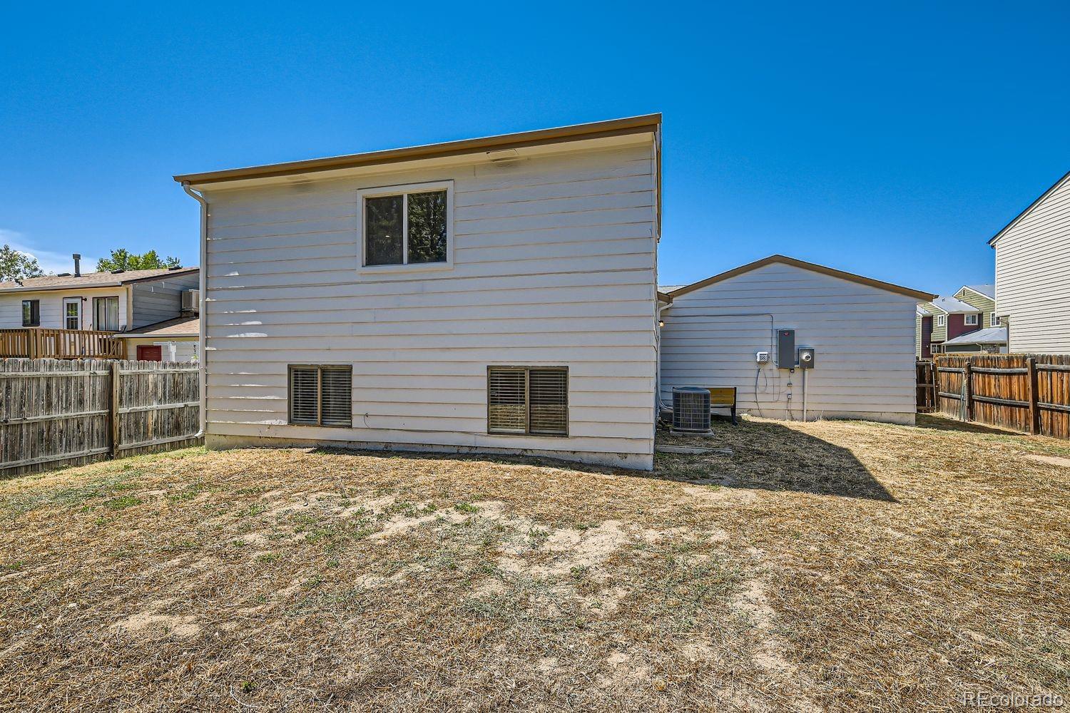 4600 Dillon Street Denver, CO 80239 - Photo 25 of 27 a front view of a house with a yard