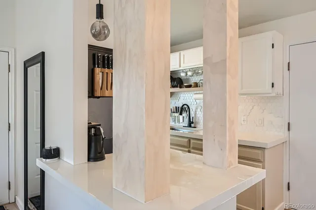 a view of kitchen and living room with wooden floor