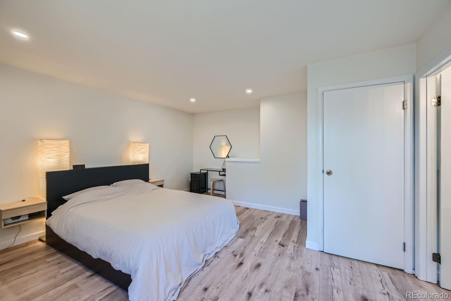 4600 Dillon Street Denver, CO 80239 - Photo 10 of 27 a bedroom with a bed and a table