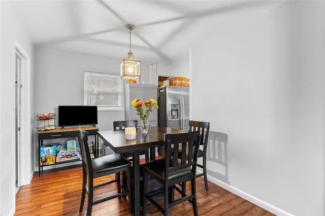 a view of a dining room with furniture and wooden floor