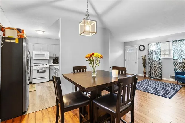 a view of a dining room with furniture and wooden floor