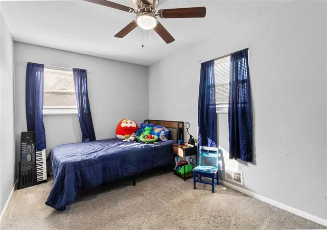 a bedroom with a bed a desk and chair