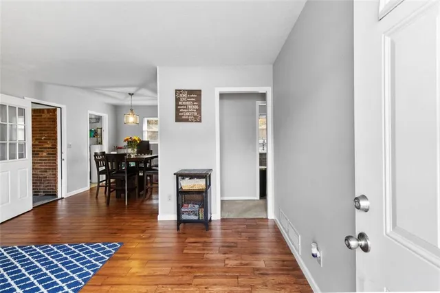 a view of a livingroom with furniture and hardwood floor