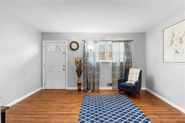 a view of a livingroom with furniture and wooden floor