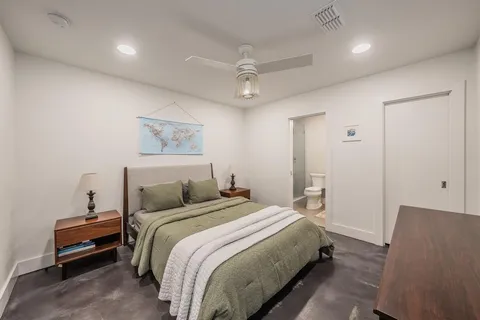 a bedroom with a bed and a lamp