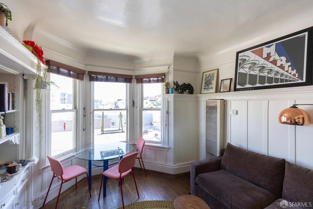 a living room with furniture cabinets and a window