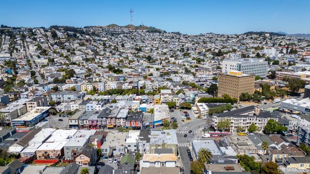an aerial view of a large building with a city view
