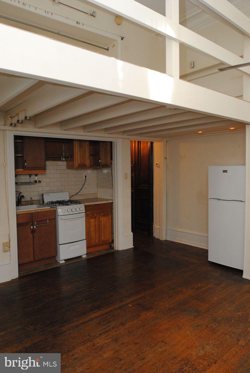 2008 Spruce Street, Unit 1F Philadelphia, PA 19103 - Photo 13 of 15 a kitchen with granite countertop a stove and a refrigerator
