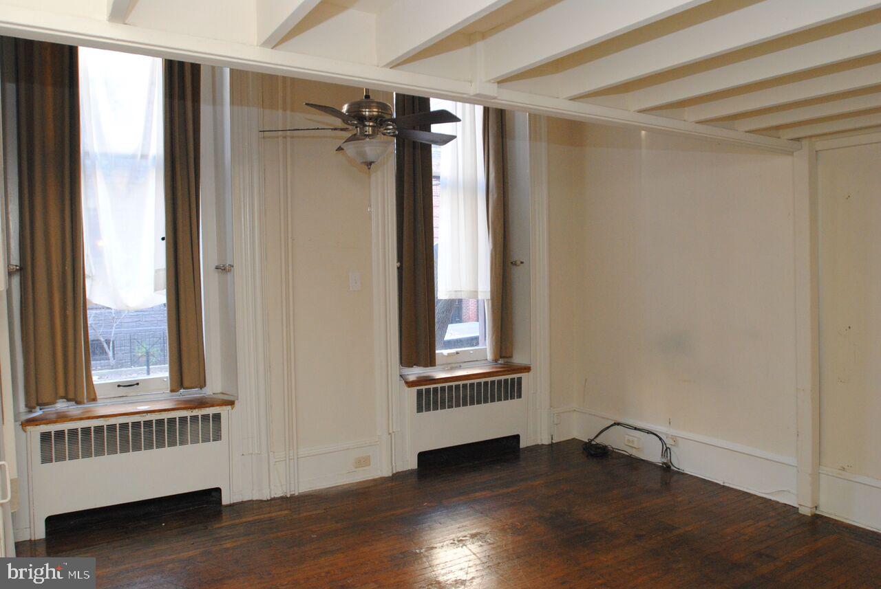 2008 Spruce Street, Unit 1F Philadelphia, PA 19103 - Photo 3 of 15 a view of an empty room with wooden floor and a window