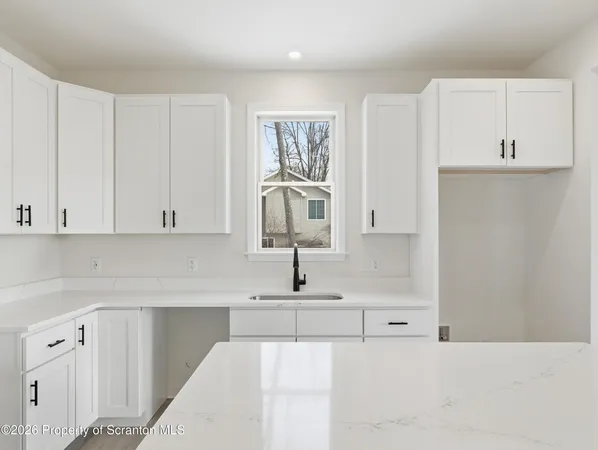 a kitchen with a sink and cabinets