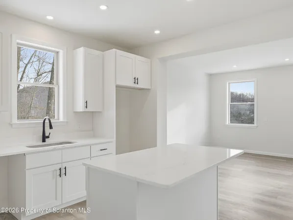 a kitchen with a sink cabinets and window