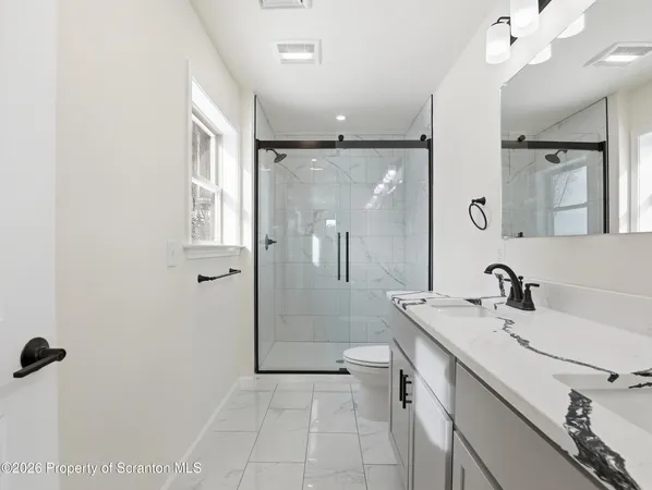 a bathroom with a sink a mirror and a shower