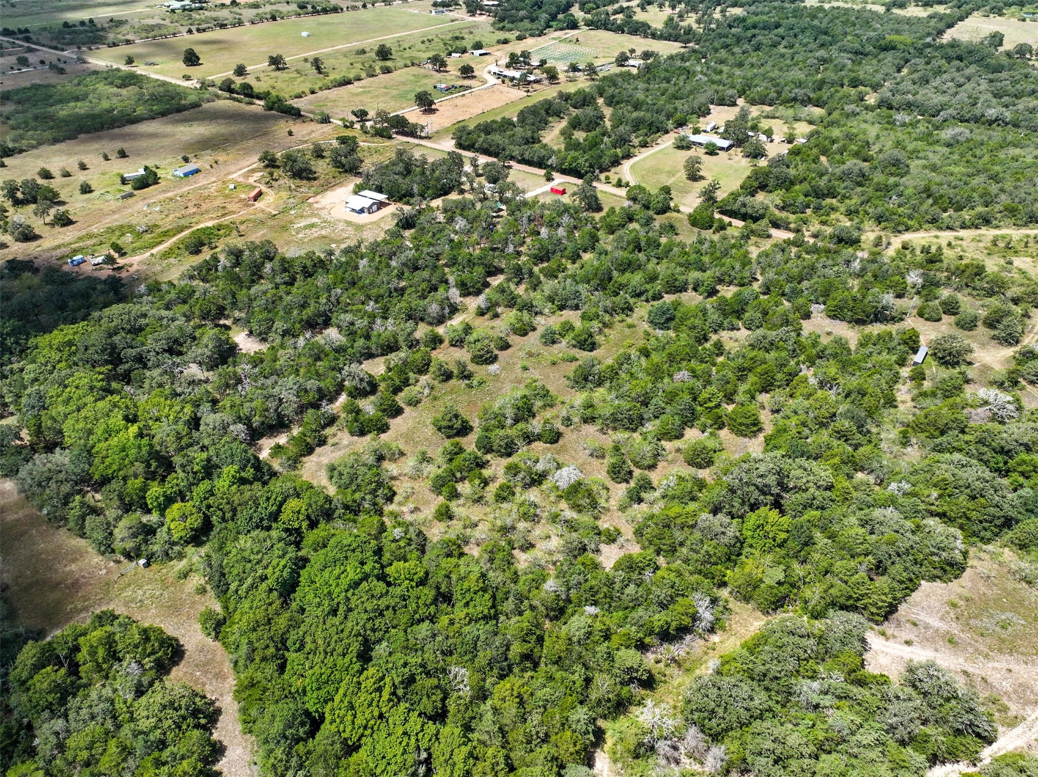 10667 Roy Road Flatonia, TX 78941 - Photo 11 of 16 an aerial view of residential house with parking space and covered by trees