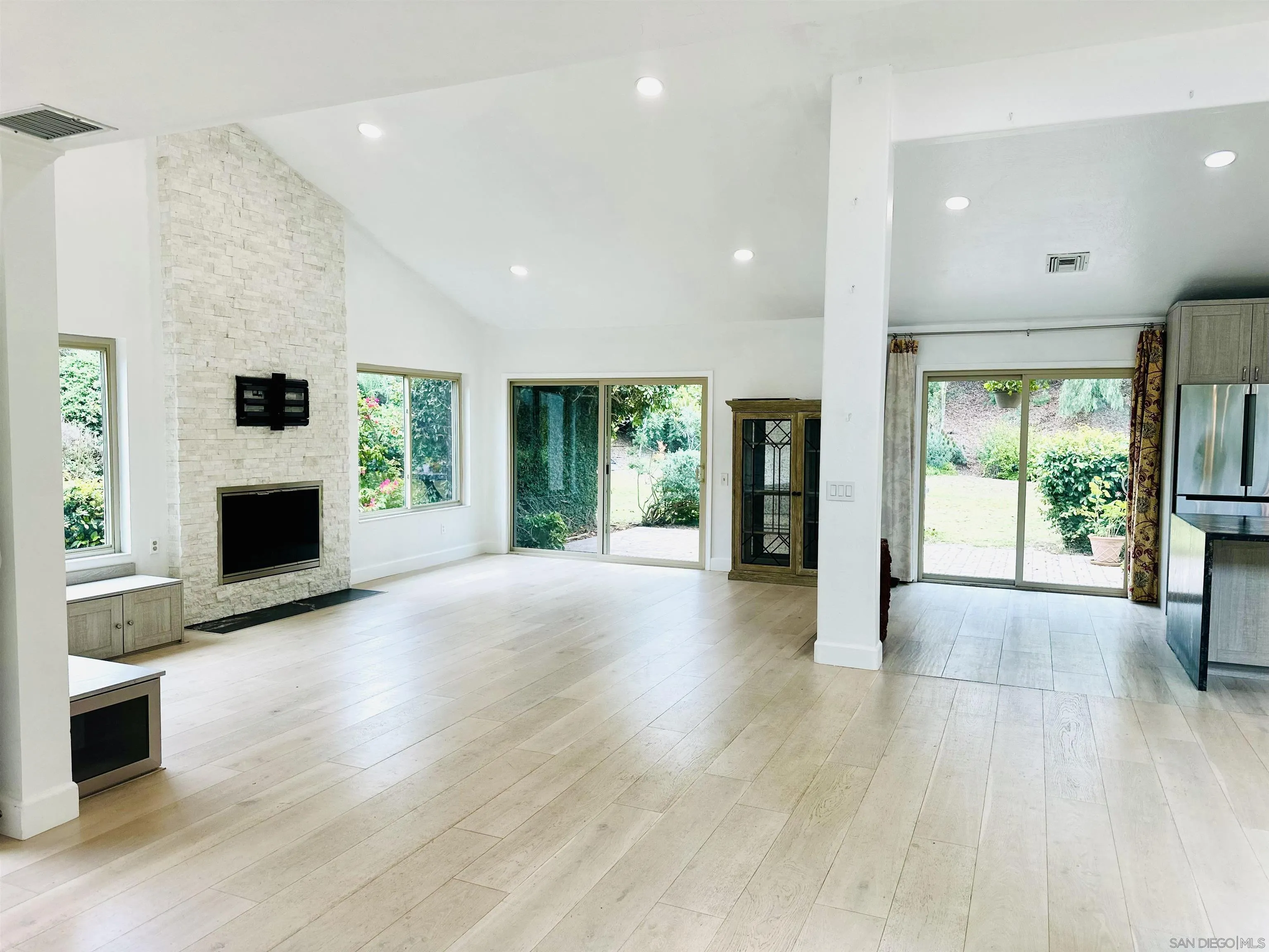 2310 Via Munera La Jolla, CA 92037 - Photo 16 of 50 a view of an empty room with a fireplace and a window