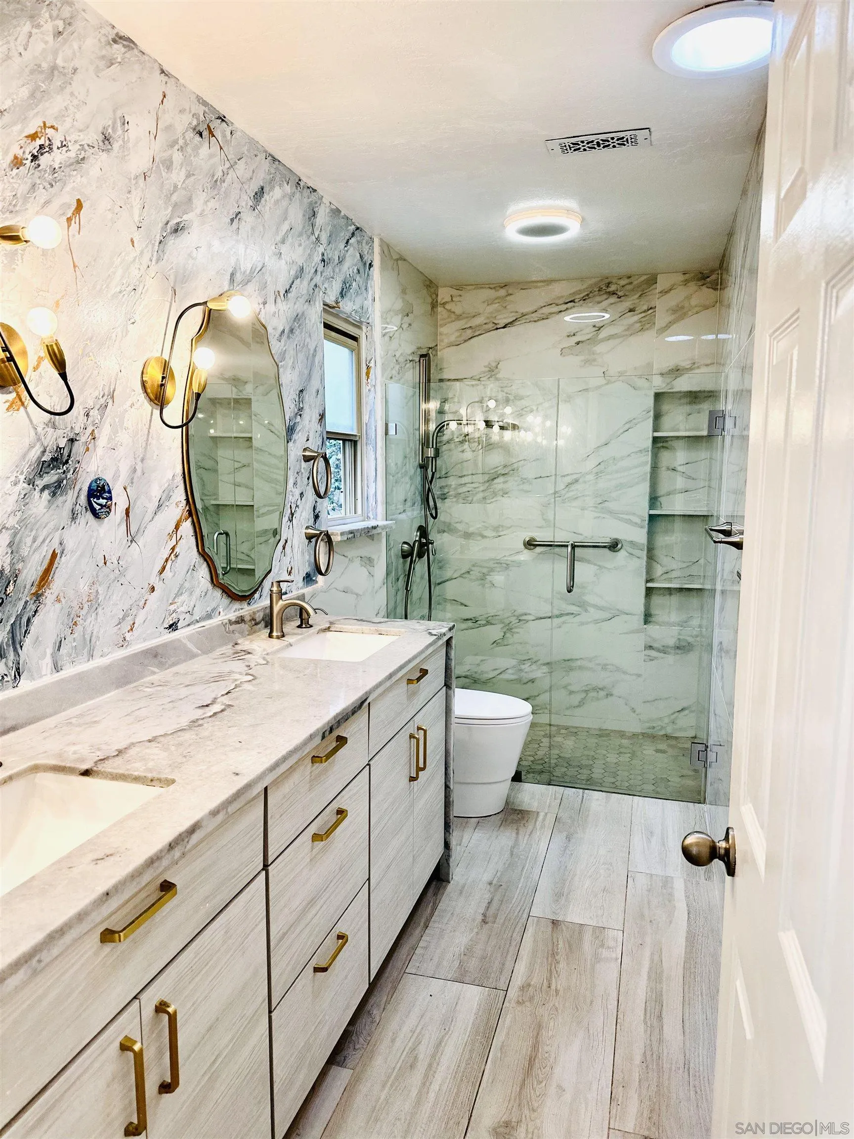 2310 Via Munera La Jolla, CA 92037 - Photo 29 of 50 a spacious bathroom with a granite countertop sink mirror and shower