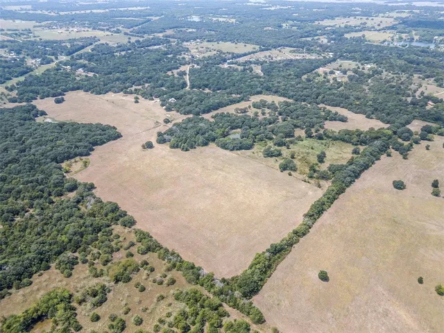 an aerial view of beach and lake