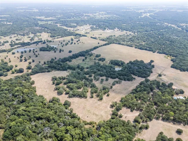 an aerial view of a houses with a yard