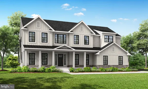 a front view of a house with a yard and green space