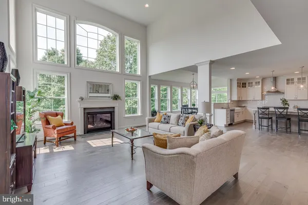 a living room with fireplace furniture and a large window