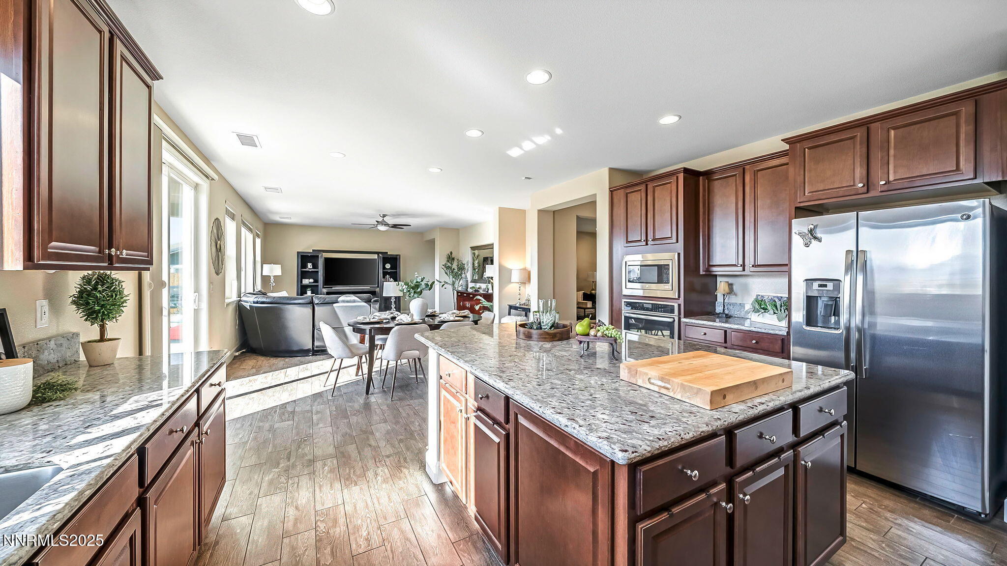 10115 Barrel Racer Drive Reno, NV 89521 - Photo 11 of 74 a kitchen with granite countertop kitchen island stainless steel appliances a sink stove and refrigerator