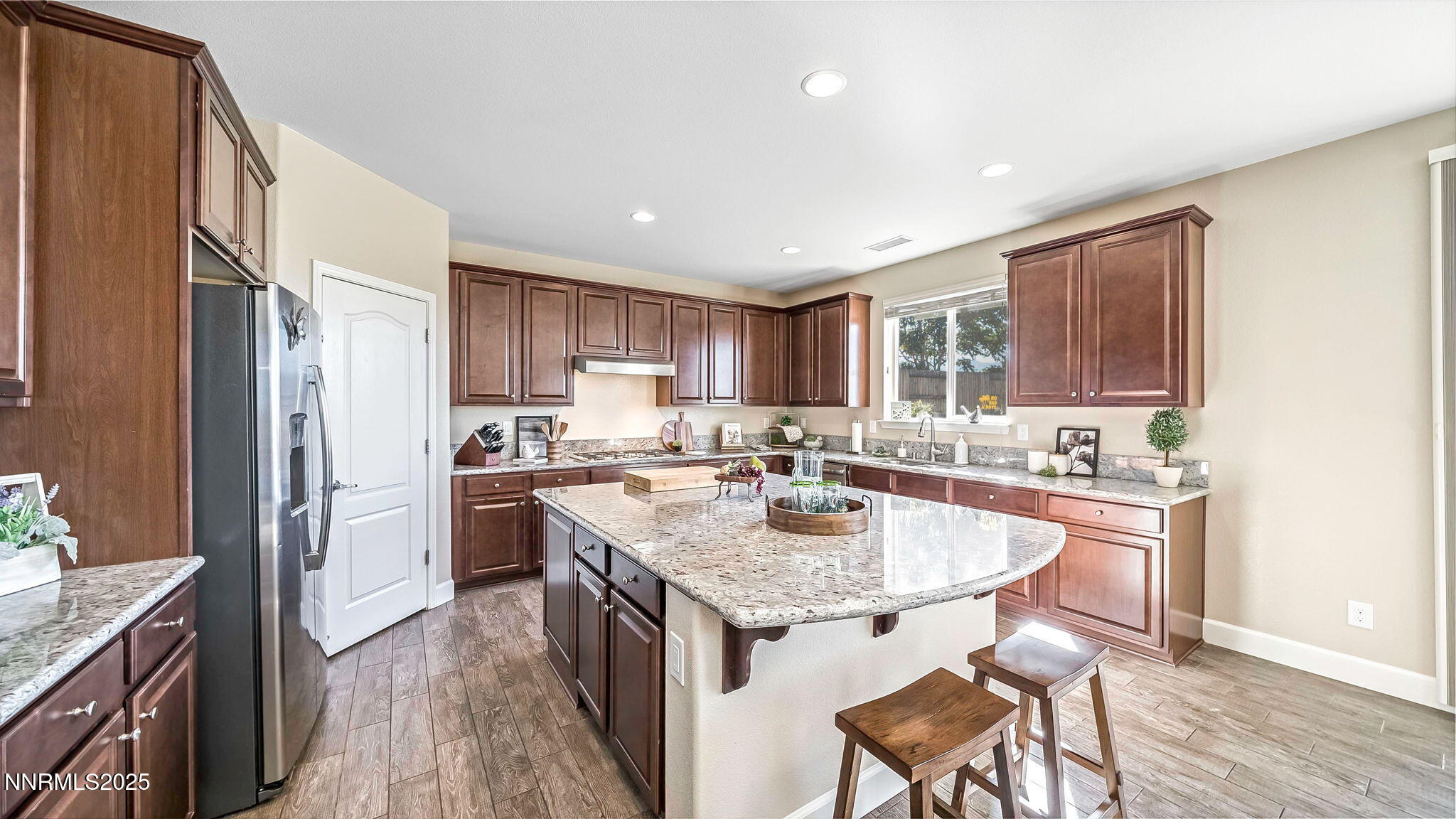 10115 Barrel Racer Drive Reno, NV 89521 - Photo 12 of 74 a kitchen with a sink a stove a refrigerator and wooden cabinets