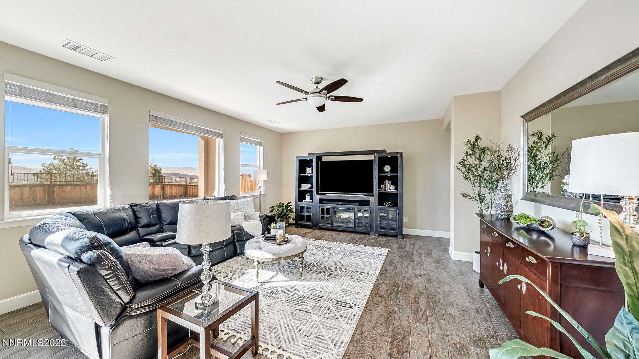 10115 Barrel Racer Drive Reno, NV 89521 - Photo 46 of 74 a living room with furniture a flat screen tv and a large window