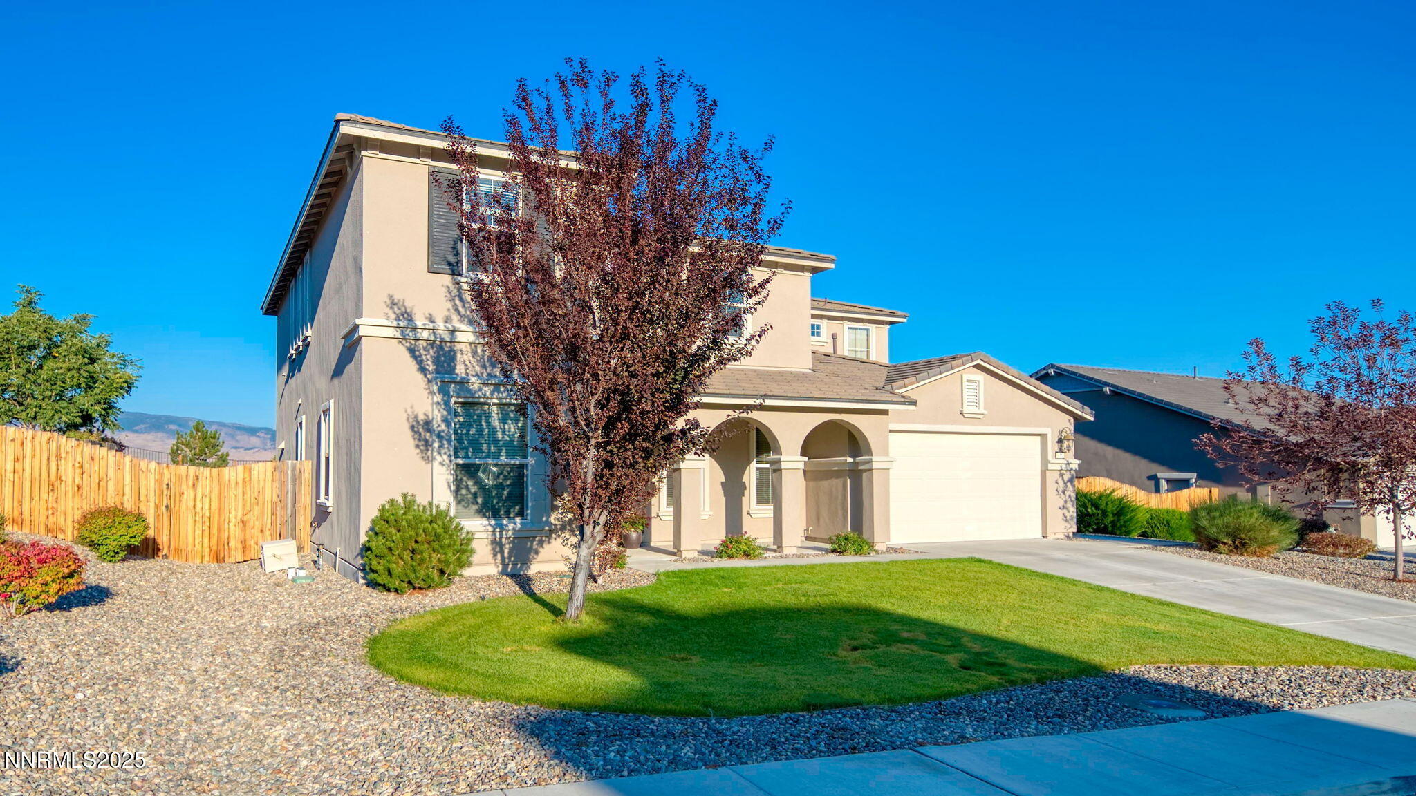 10115 Barrel Racer Drive Reno, NV 89521 - Photo 50 of 74 a view of a white house with a big yard and large trees