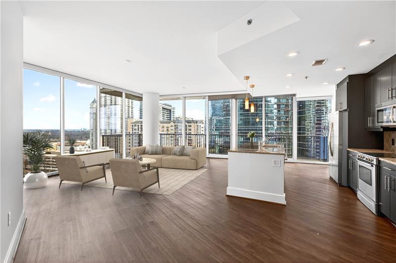 a living room with furniture large windows and wooden floor
