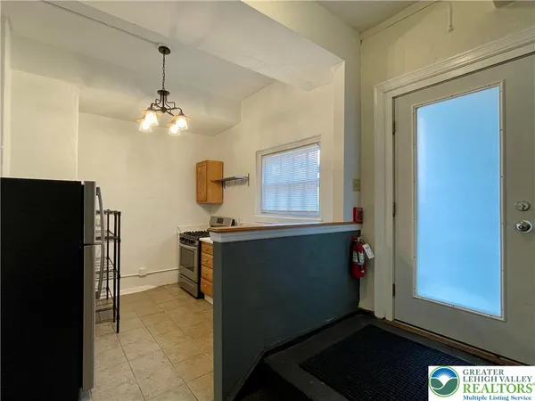a kitchen with a refrigerator and cabinets