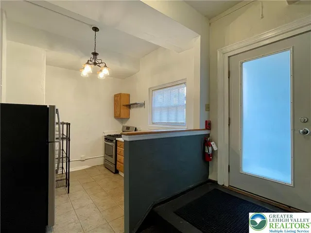 a kitchen with a refrigerator and cabinets