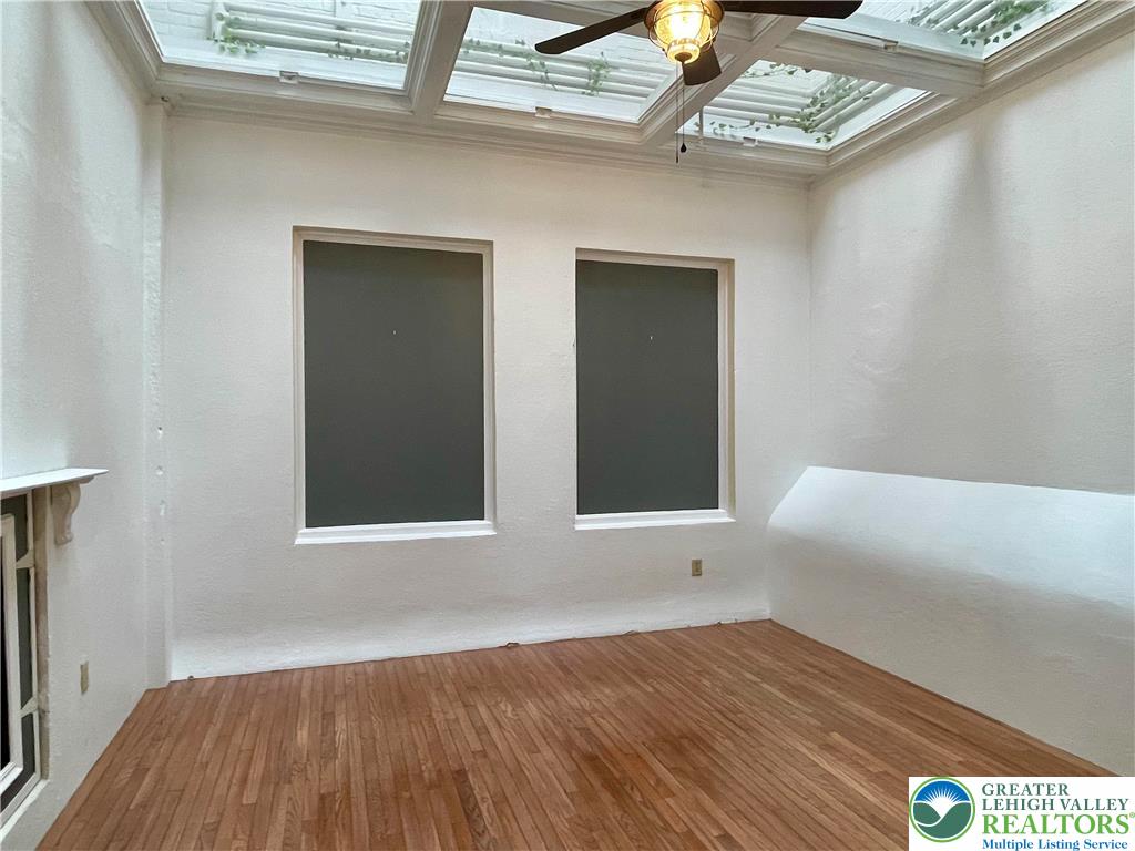 147 South 4th Street, Unit 3 Easton, PA 18042 - Photo 8 of 21 a view of an empty room with wooden floor and a window