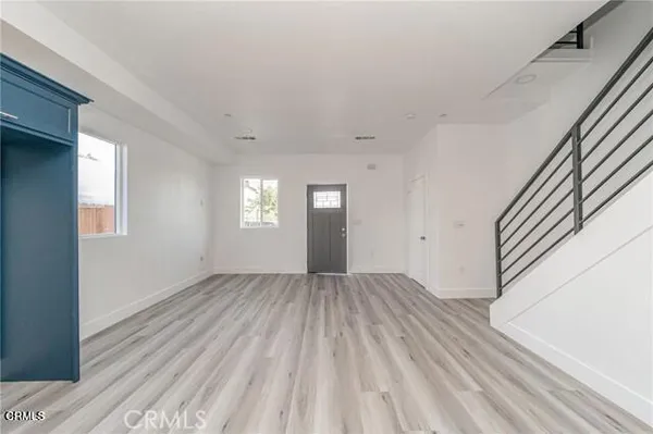 a view of wooden floor and windows in a room