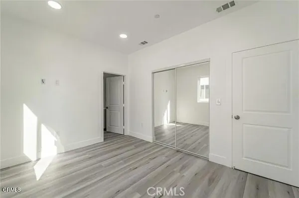 a view of hallway with wooden floor