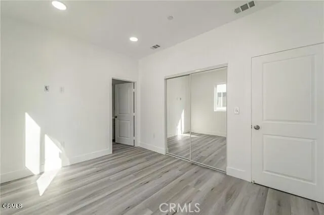 a view of hallway with wooden floor