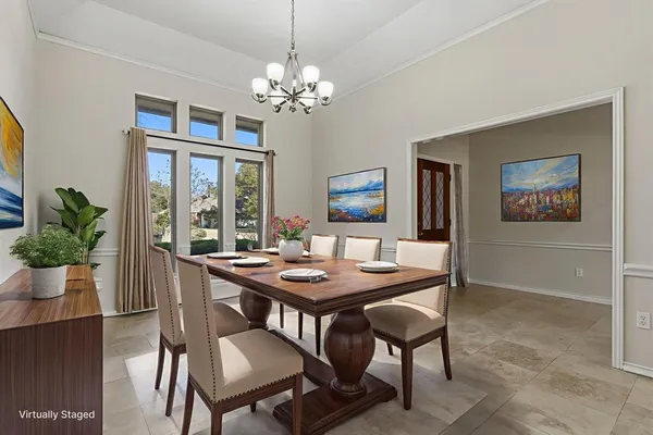 a view of a dining room with furniture and a chandelier
