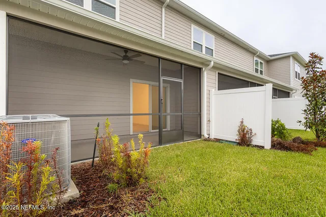 a view of a house with backyard and porch