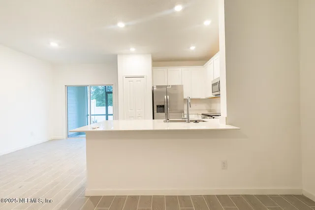 a view of kitchen with counter top space and appliances