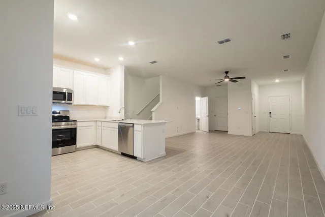 a view of a kitchen with stove and cabinets