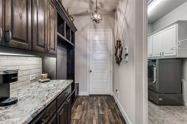 a kitchen with granite countertop stainless steel appliances a sink stove top oven and cabinets