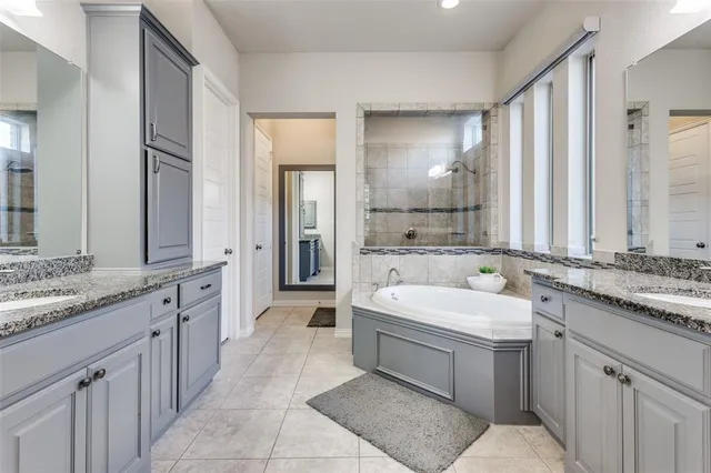 a spacious bathroom with a double vanity sink mirror double and bathtub