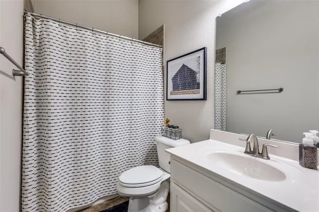 a bathroom with a sink a toilet and mirror