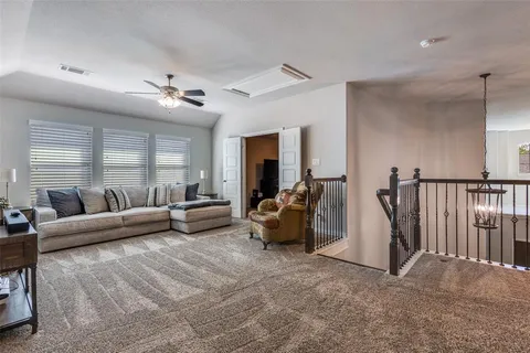 a living room with furniture and a chandelier