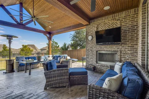 a outdoor living space with patio furniture and a fireplace