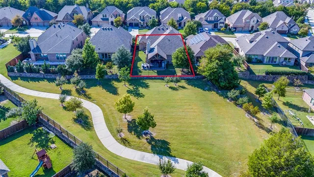an aerial view of residential houses with outdoor space and swimming pool