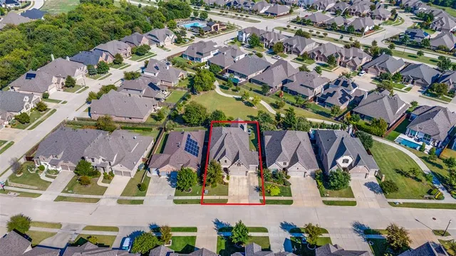 an aerial view of multiple houses with yard