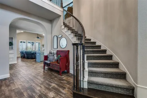 a view of entryway livingroom and hall with wooden floor